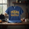 Blue t-shirt with "Texas Waffle" in yellow distressed collegiate font, featuring waffle graphics and a Texas star emblem