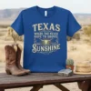 Texas Where You Never Have To Shovel Sunshine quote on a blue t-shirt with a steer skull graphic