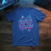 Thankful For You F*ckers quote in neon retro font on a blue t-shirt with cityscape graphic