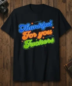 Thankful For you Fuckers neon-style text design on a black t-shirt, perfect for humorous holiday gatherings