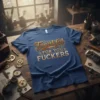Blue t-shirt with "Thankful For You FUCKERS" in vintage, distressed lettering. Features decorative swirls and underlines