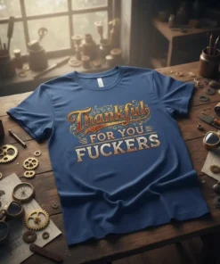Blue t-shirt with "Thankful For You FUCKERS" in vintage, distressed lettering. Features decorative swirls and underlines