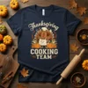 Thanksgiving Cooking Team t-shirt design with a chef turkey holding utensils, pumpkins, and corn