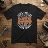 Black t-shirt with orange and white text that says "THAT'S WHAT I DO I FIX STUFF AND I KNOW THINGS"