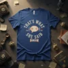 Blue t-shirt with "That's What She Said Est. Never" in distressed vintage font and a speech bubble graphic