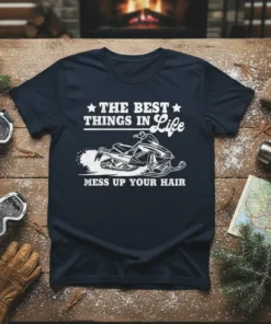 The Best Things in Life Mess Up Your Hair snowmobile graphic t-shirt design in white text and illustration