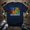 The Cool Twins Just Showed Up text in colorful, bold typography on a navy blue t-shirt