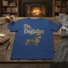 The Dogfather t-shirt design with a cartoon dachshund wearing a hat and crown, text in gothic font