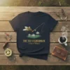 The Fly Fisherman Catch & Release quote on a dark navy t-shirt, featuring a graphic of flies and a fishing
