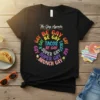 Black t-shirt with colorful text "The Gay Agenda BE GAY BE GAY TACOS BE GAY SUPER GAY SUPER GAY BRUNCH