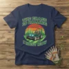 The Grass Is Calling And I Must Mow t-shirt with a lawn mower graphic and sunset background