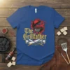 The Grillfather t-shirt design featuring a flaming grill and crossed spatula and fork, in vintage style typography