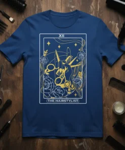 The Hairstylist Tarot Card T-Shirt featuring golden scissors and comb on navy blue background