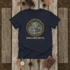 Navy t-shirt with a circular vintage design featuring stacked logs, text "The Heart of The Forest" and "Natural Lumber Supply