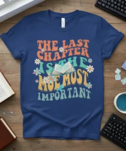 Retro t-shirt design with text "The Last Chapter Is The Most Important" and an open book graphic surrounded by flowers