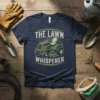 The Lawn Whisperer t-shirt featuring a vintage-style riding mower graphic and distressed text