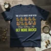 T-shirt with white text "THE LITTLE VOICES IN MY HEAD" above a row of illustrated ducks, followed by cursive text