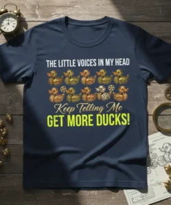 T-shirt with white text "THE LITTLE VOICES IN MY HEAD" above a row of illustrated ducks, followed by cursive text
