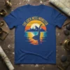 The Loch Ness Monster vintage sunset design with mountains and water reflection on a blue t-shirt