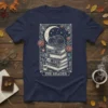 The Reader t-shirt design with a sleeping black cat on stacked books, crescent moon, stars, and floral border