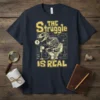 The Struggle Is Real t-shirt design with a skeleton T-Rex on a toilet, featuring yellow text and blueprint graphics