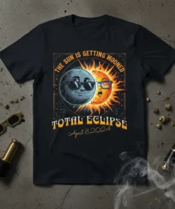 T-shirt graphic for "The Sun Is Getting Mooned Total Eclipse April 8, 2024" featuring a cartoon sun and moon wearing