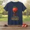 The Sweeter The Berry T-Shirt featuring a chocolate-dipped strawberry graphic and gold text