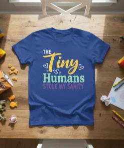 The Tiny Humans Stole My Sanity quote on a blue t-shirt, featuring playful yellow, green, and purple text with small