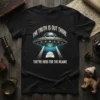 Black t-shirt featuring a vintage-style UFO beaming down on a beanie with the text "The Truth Is Out There They're