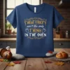 The Turkey Ain't The Only Thing In The Oven t-shirt design with gold and white text and baby feet graphics