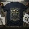 Navy t-shirt with gold art deco design featuring text "The Unsen Architects of Reality - We Shape Silence"