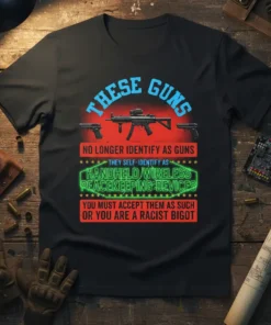 T-shirt design with bold text "THESE GUNS NO LONGER IDENTIFY AS GUNS THEY SELF-IDENTIFY AS HANDHELD WIRELESS PEACEKEEPING DEVICES YOU