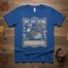 They Are Eating The Turkeys quote with a distressed turkey graphic and cutlery, on a royal blue t-shirt