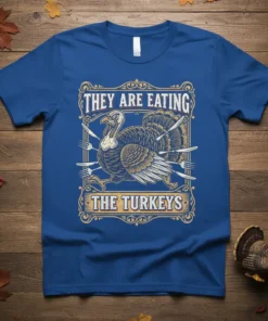 They Are Eating The Turkeys quote with a distressed turkey graphic and cutlery, on a royal blue t-shirt