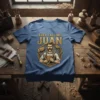 Carpenter with hammers and tools, text "THEY CALL ME JUAN" on a blue t-shirt