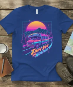 Retro RV camper van design with the text "They See me Rollin'" on a blue t-shirt, featuring a vibrant sunset