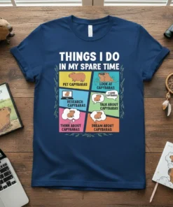 Graphic t-shirt design titled "Things I Do In My Spare Time" with six panels depicting capybara activities like petting, looking