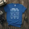Blue t-shirt with white text and graphics detailing fishing activities: "Things I Do In My Spare Time Fishing," including icons