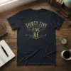 Navy t-shirt with gold distressed text "THIRTY FIVE FIVE AF" in vintage typography, celebrating a 35th birthday