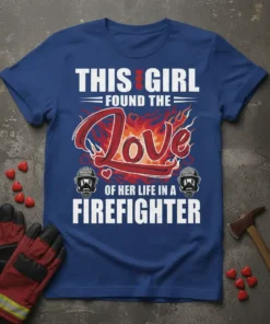"This Girl Found The Love Of Her Life In A Firefighter" quote on a blue t-shirt with graphic flames and