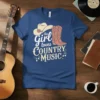 This Girl Loves Country Music text with cowboy hat and boots graphic on a blue t-shirt