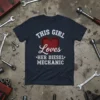 THIS GIRL Loves HER DIESEL MECHANIC text with a red heart on a navy t-shirt, surrounded by tools