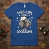 This Girl Loves Opossums t-shirt design featuring two hugging opossums and scattered hearts