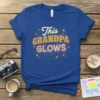 This Grandpa Glows text design on a royal blue t-shirt with sparkling star accents