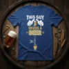 Blue t-shirt with white text "THIS GUY NEEDS A BEER" and graphics of thumbs up and beer pouring from a