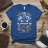 Blue t-shirt with "This Hair Stylist is Powered by Dogs and Coffee" text, featuring dog and coffee graphics
