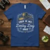 This Is My Derby Day Suit text with a vintage hat graphic on a blue t-shirt, featuring floral accents and