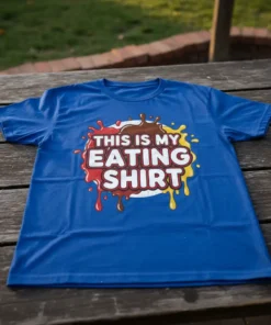 Blue t-shirt with "This Is My Eating Shirt" text in white, red, brown, and yellow, surrounded by colorful paint splatters