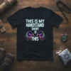 Black t-shirt with "THIS IS MY HANDSTAND SHIRT SI THIS" text and colorful hand graphics, perfect for gymnasts and fitness