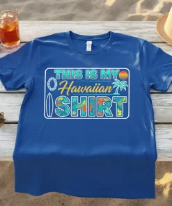 This Is My Hawaiian Shirt text with tropical graphics including palm trees, flowers, and a surfboard on a blue t-shirt